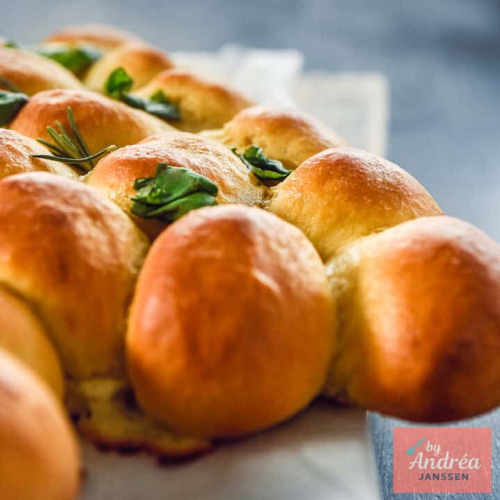 A square picture with half of the Christmas tree of buns filled with cheese