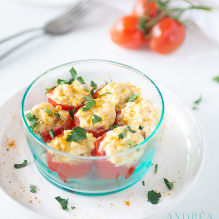 a bowl with With egg salad stuffed tomatoes
