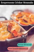 Twee ovenschaaltjes gevuld met moussaka op een houten plank. Een tekst: eenpersoons Griekse Moussaka