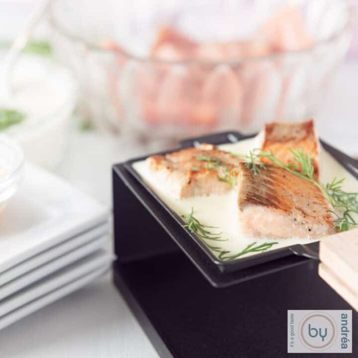 Een vierkante foto met een gourmetschaaltje gevuld met drie blokjes gemarineerde zalm in een dille roomsaus