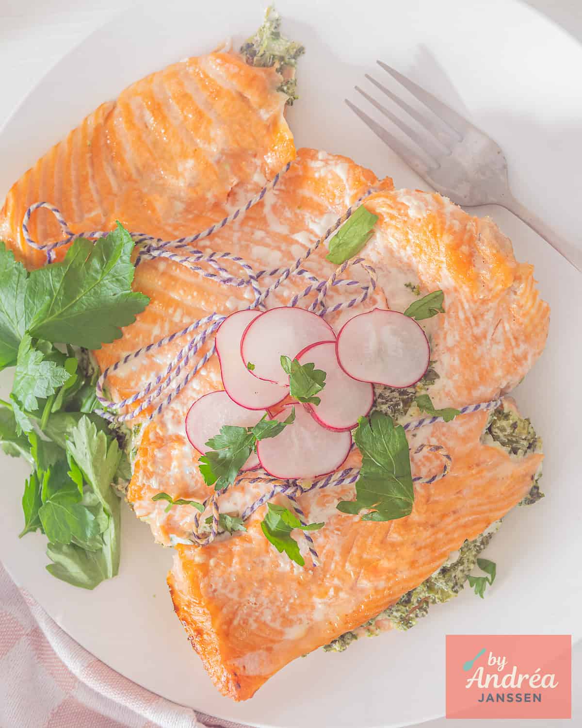 An overhead photo of a salmon fillet stuffed with a creamy spinach celery mixture