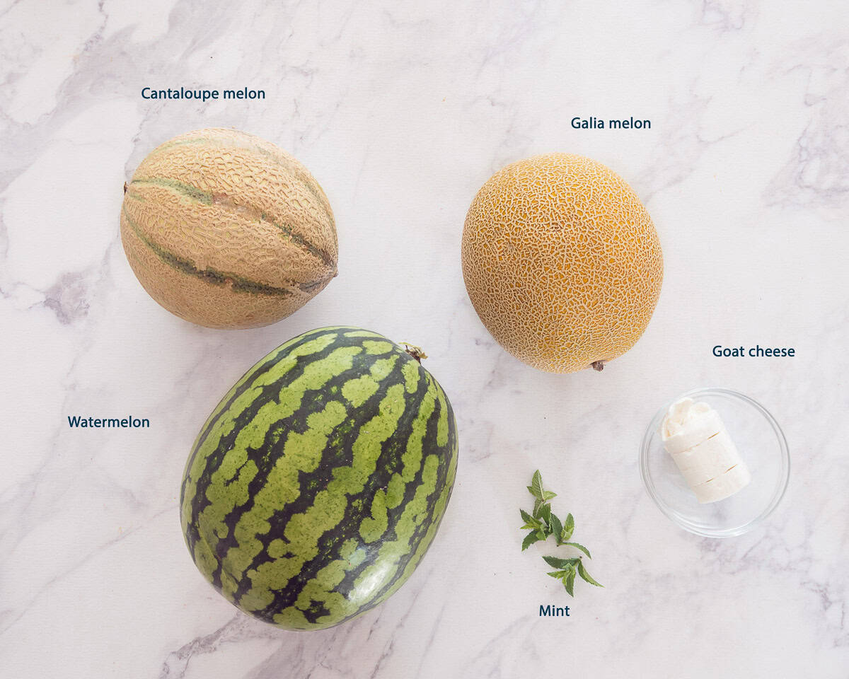 Ingredients Melon Salad With Goat Cheese And Mint on a white marble background with text description