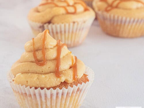 A square picture with cupcakes with caramel frosting and salted caramel drippings