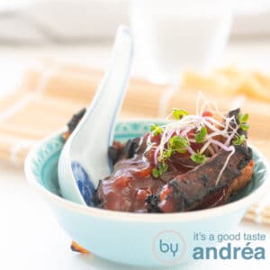 square photo of babi pangang in a blue bowl