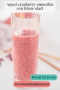Een glas met cranberry en appel smoothie. Een tekst: appel cranberry smoothie - een frisse start
