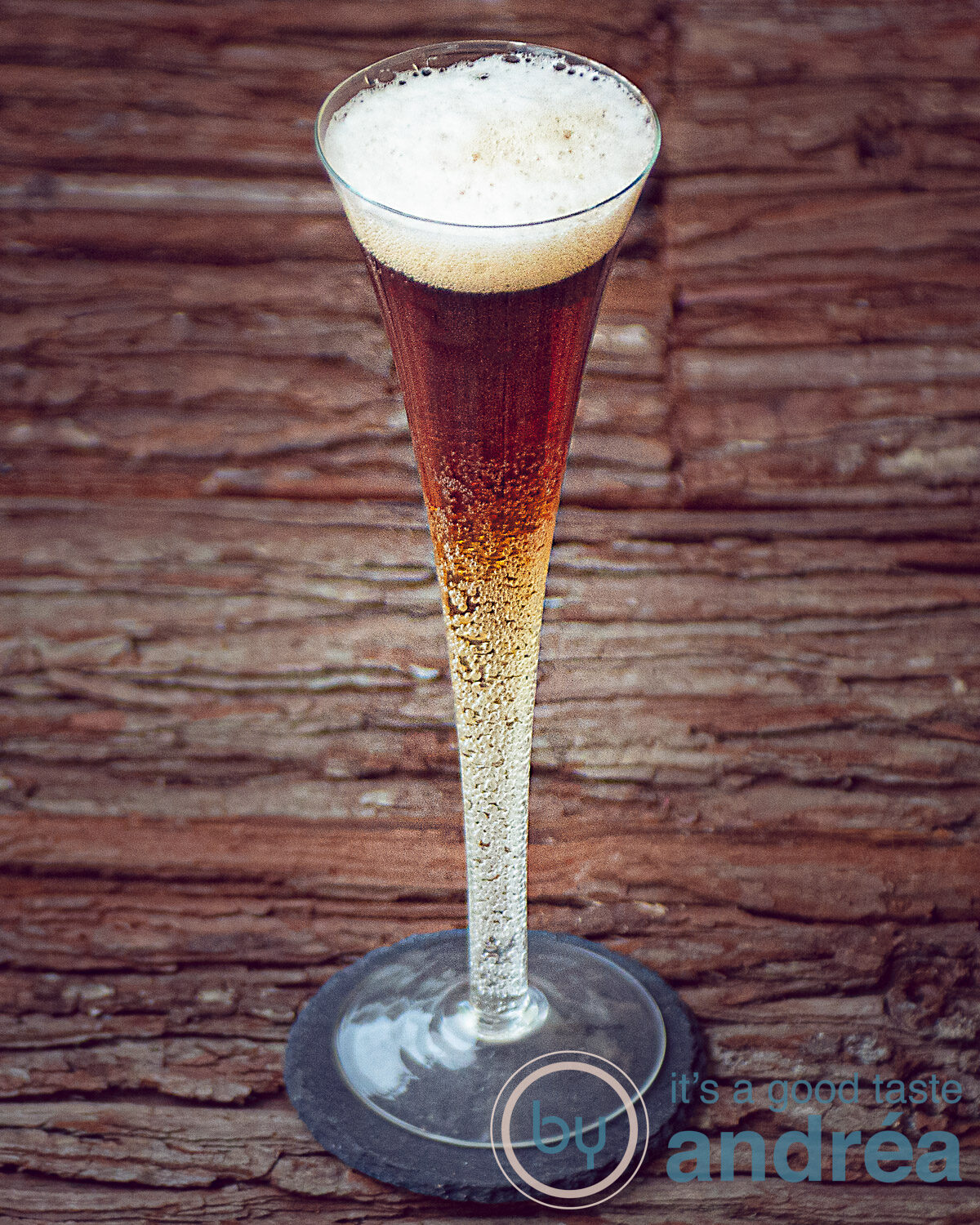 Beer cocktail in a cocktail glasses, with two layers (light and dark) on a wooden background