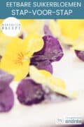 Een hoogtefoto met gesuikerde viooltjes met een tekst: eetbare suikerbloemen maken, makkelijk recept