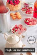 Een tafel gedekt met high tea met aardbeien recepten. een tekst bovenin: High tea met aardbeien