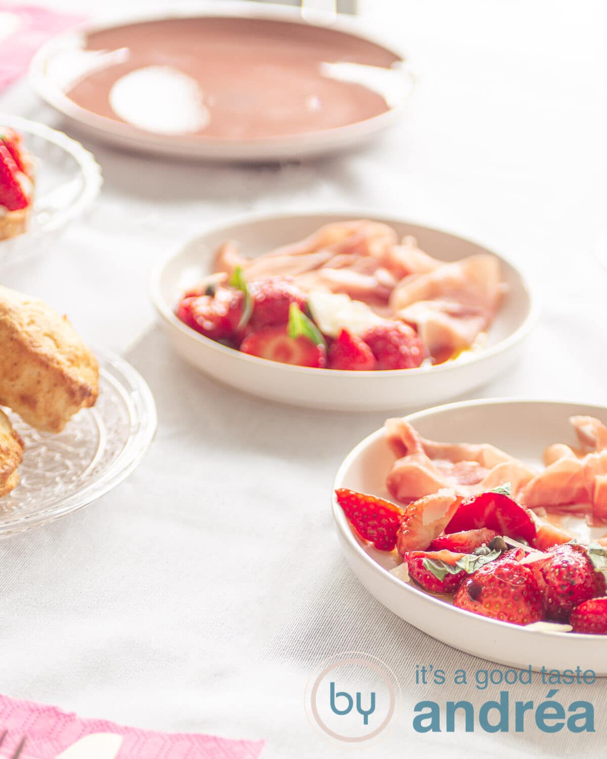 strawberries marinated in balsamic vinegar on a plate and some scones