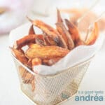 A square photo with a bowl filled with sweet potato fries