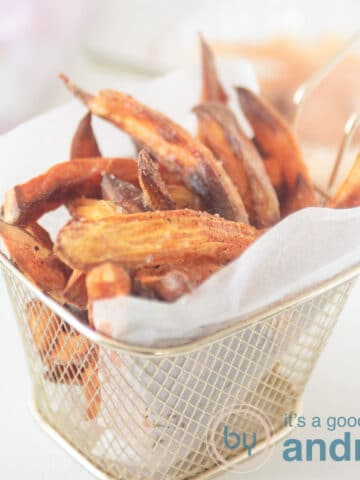 A square photo with a bowl filled with sweet potato fries