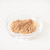 Galangal powder in a glass dish on a white background