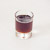 Maple syrup in a glass on a white background