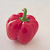 Een rode paprika op een witte ondergrond