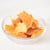 Tortilla chips in a glass bowl on a white background