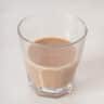 A glass bfilled with Amurula on a white background