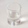 A glass with Cointreau on a white background
