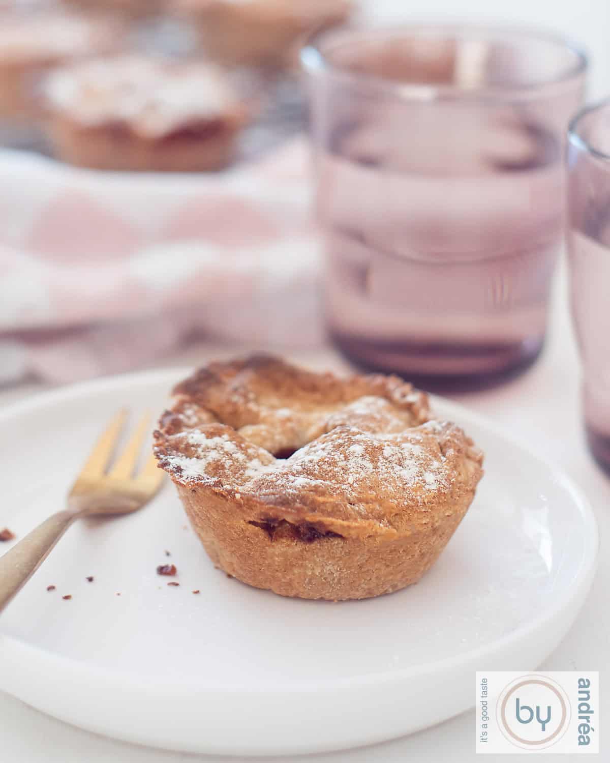 mini appelgebakjes met een glas water.