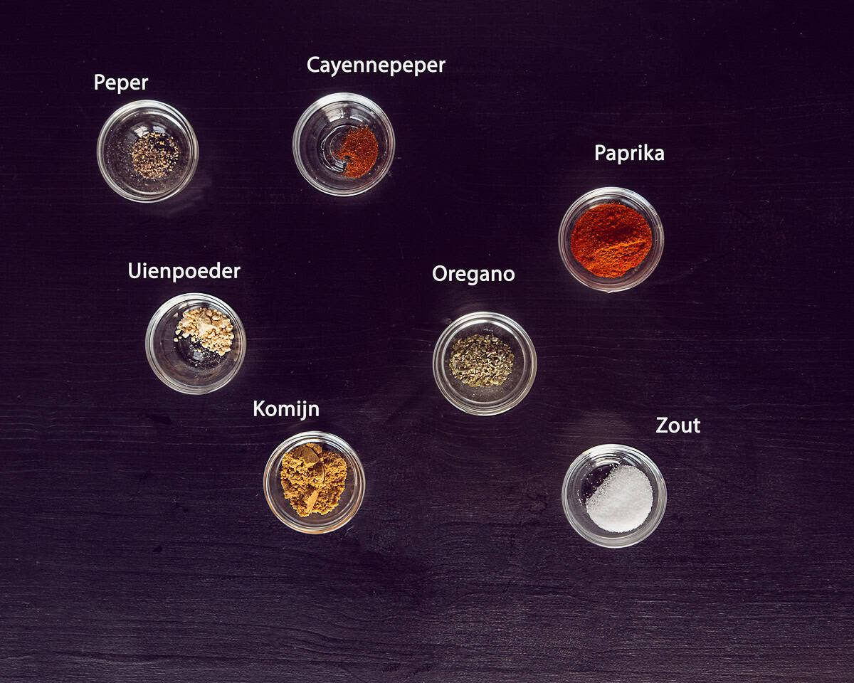 Ingredienten Burrito Kruidenmix Voor Gehakt Zelf Maken op een zwarte ondergrond met tekst beschrijving.