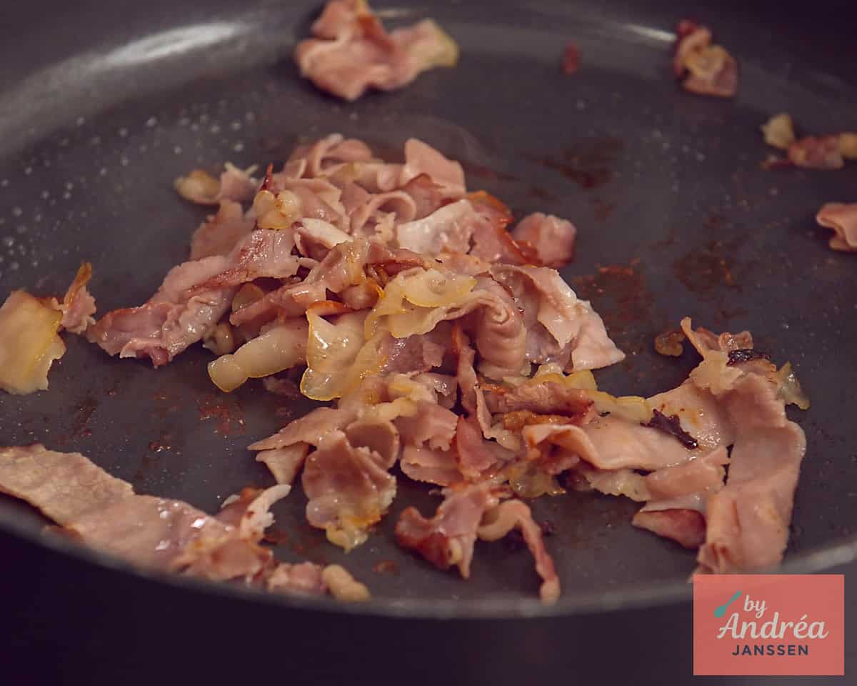 Een koekenpan waar bacon wordt uitgebakken