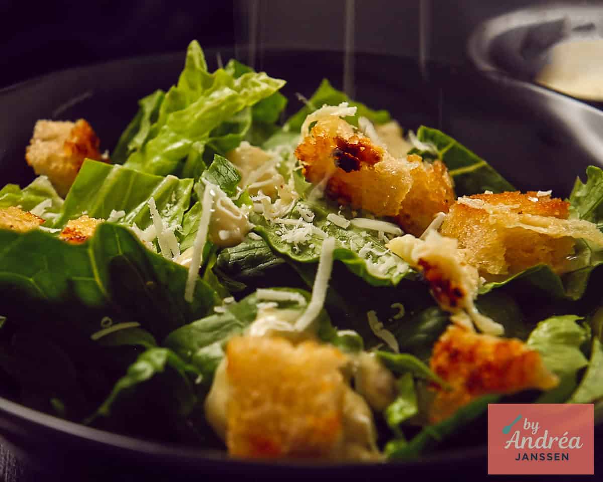 Rasp Parmezaanse kaas over de Caesar Salade